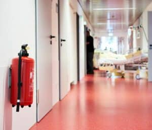 Symbolbild: Brandschutz in Pflegeeinrichtungen: Krankenhaus mit Feuerlöscher